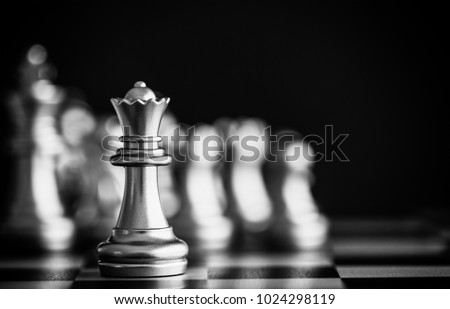 The King in battle chess game stand on chessboard with black isolated background. Business leader concept for market target strategy. Intelligence challenge and business competition success play. Royalty-Free Stock Photo #1024298119