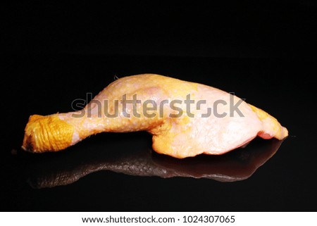 Duck leg raw meat on black reflective studio background. Isolated black shiny mirror mirrored background for every concept.