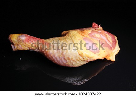 Duck leg raw meat on black reflective studio background. Isolated black shiny mirror mirrored background for every concept.