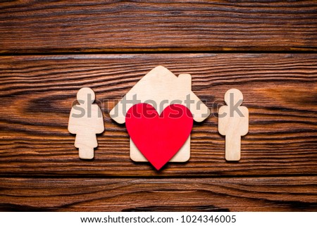 Symbol of home and family on a wooden background 