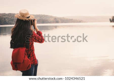 Asian woman shooting picture in nature , Relax time on holiday concept travel,selective and soft focus,tone of hipster style