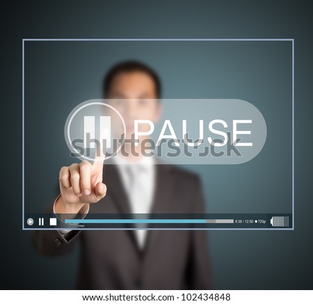business man push pause button on touch screen to hold video clip Royalty-Free Stock Photo #102434848