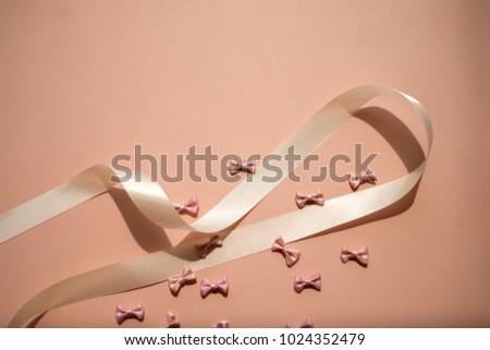 bows background on pink. pastel ribbon and pretty girly. abstract wallpaper pattern.