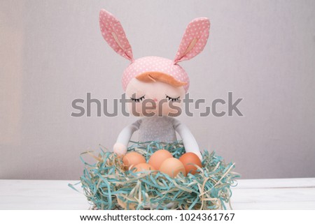 an easter bunny sitting behind chicken eggs as a tradition