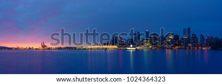 Panoramic view of Vancouver Skyline at Sunrise with City Lights as seen from Stanley Park, Vancouver, British Columbia, Canada