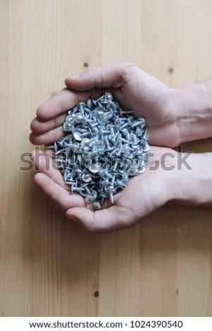 full hands of white screws