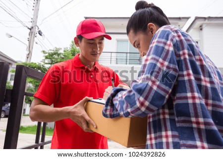 Woman accepting a delivery of boxes from delivery service courier. Isolated on a White Background.