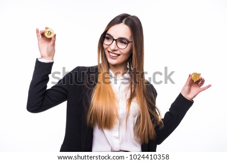 young successful confident woman with glasses holds a gold bitcoin in her hand