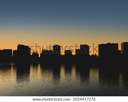 Oakland California Downtown City Skyline Above Lake Merritt at Dusk Evening