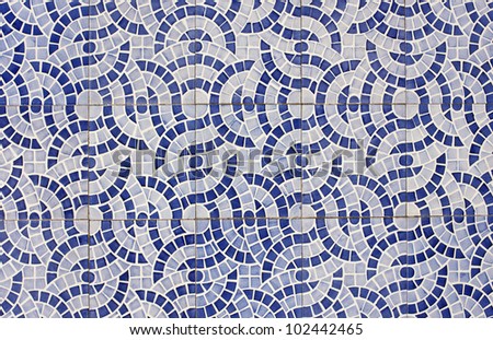 Mosaic of old tiles with abstract design in two shades of blue