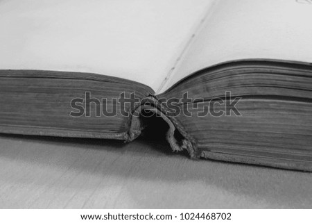 Open old book on a wooden background. on the side.