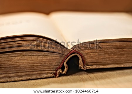 Open old book on a wooden background. on the side.