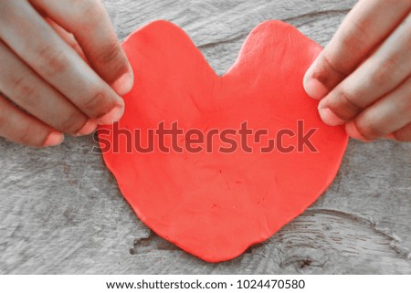 I love you Mom, Mother's Day celebration with parent woman holds young kid's hands supporting red heart, csr charity donation for nursing and parenting children adoption. Royalty-Free Stock Photo #1024470580