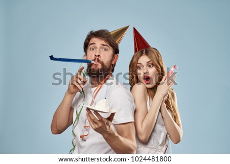  holiday, young couple celebrating a birthday on a blue background                             