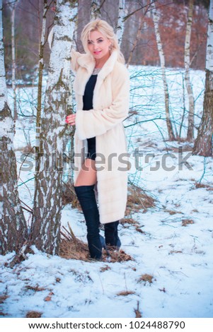 Close-up portrait of happy girl  enjoying winter moments. Outdoor photo of long-haired laughing lady having fun in snowy morning on nature background