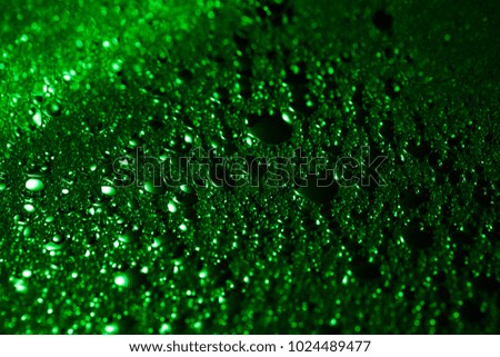 
green colorful small soap bubbles with backlight