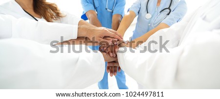 Doctors and nurses in a medical team stacking hands Royalty-Free Stock Photo #1024497811