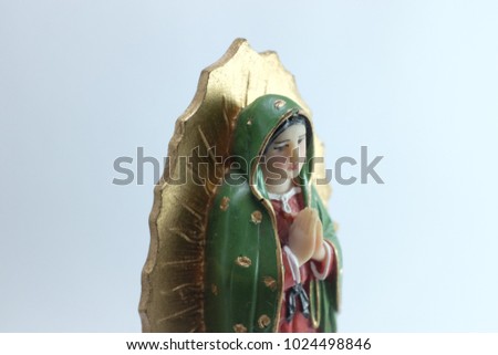 Closed Up Small Figure of Blessed Virgin Mary in Roman Catholic Church on white background.
