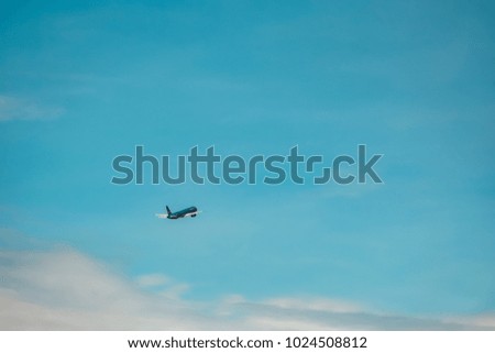 Royalty high quality free stock image of a plane in blue sky with white cloud