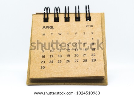 Brown old vintage desk calendar of April of 2018 isolated on white background
