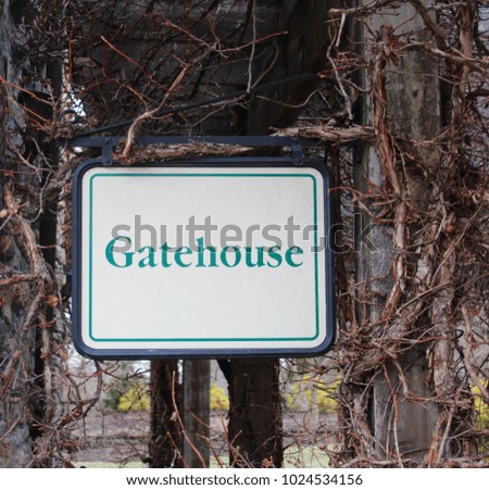 The gatehouse sign in the park on a close up view.