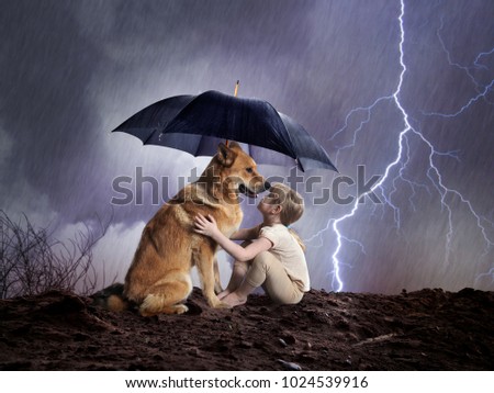 Child and dog under an umbrella.  Royalty-Free Stock Photo #1024539916