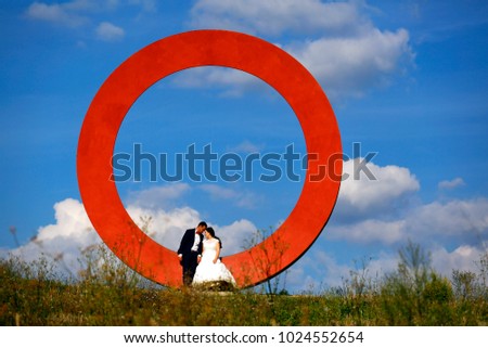 Amazing summer view of bride and groom in front of countryside in Tuscany 