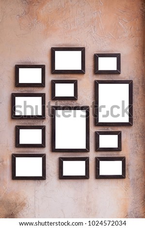 A lot of wooden picture and photo frames stick on vintage wall for house decoration.  Art wall by wooden photo and picture frame vintage style.