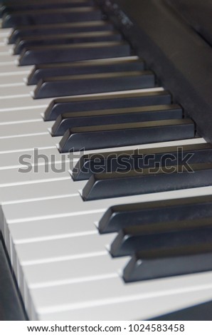 white and black piano keys close up