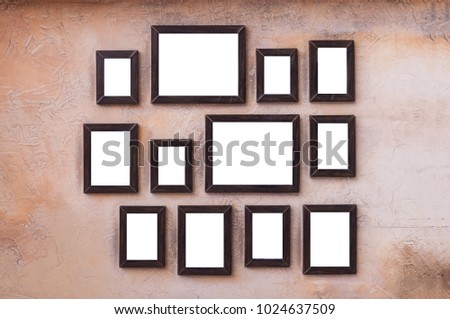 A lot of wooden picture and photo frames stick on vintage wall for house decoration.  Art wall by wooden photo and picture frame vintage style.