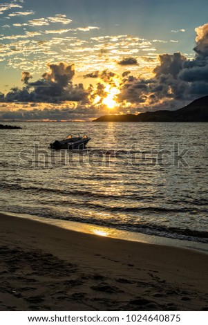 Ilhabela beach Pereque with boat in the sea at sunset - Sao Paulo, Brazil - wide angle photo