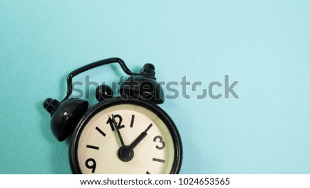 Black clock on blue background.