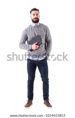 Smiling happy bearded businessman holding planner looking at camera. Full body length portrait isolated on white studio background.