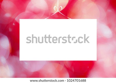 Blank greeting card on red pink abstract blurry bokeh closeup background 