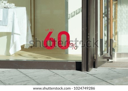 60% off. Sale and discount price sign on the wall in Department store.