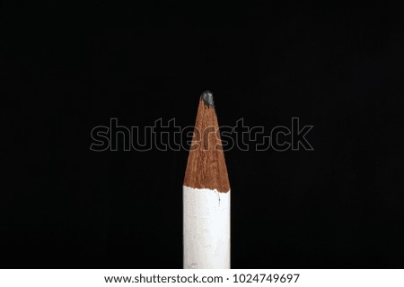 pencil against black background, close-up
