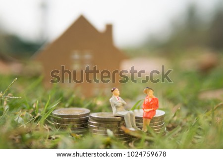 A couple of male and female are discussing about house renting or buying from bank with some coin money as business finance concpet Royalty-Free Stock Photo #1024759678