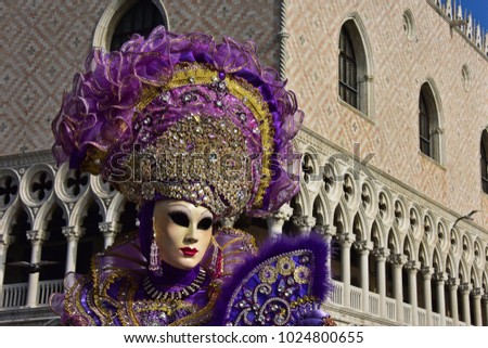 Carnival of Venice, beautiful masks at St. Mark's Square with the Doge's Palace in the background 