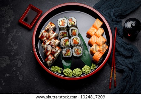 Japanese cuisine. Sushi set over dark background.