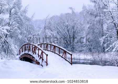 Wooden bridge above winter river
