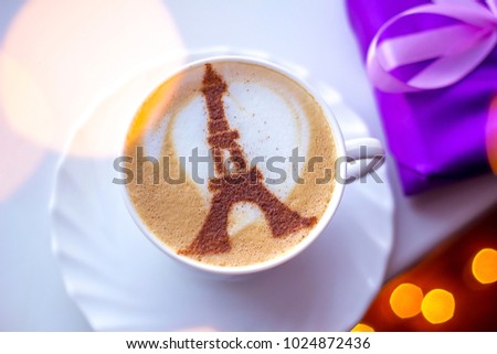 coffee cappuccino in a white cup in a cape in paris with a drawing of a tower of cinnamon