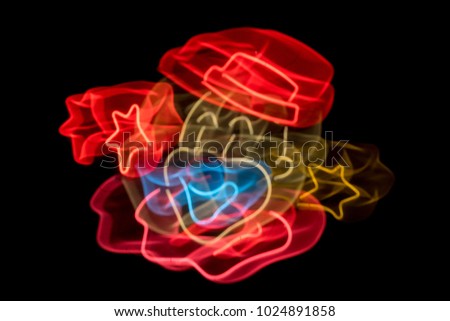 Colorful Blurred Image of Neon Clown Sign With Stars