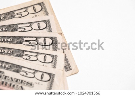 Fifty 50 dollar bills shot against a white background