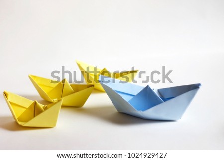 Leadership concept. Paper boats on a white background. Leader before others, paper craft and origami.
