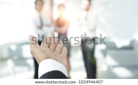 background image of businessman holding out hand for a handshake