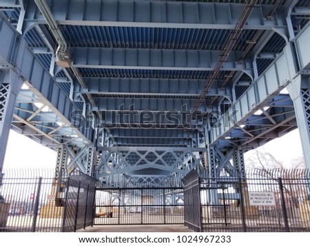 Close up from underneath of the Benjamin Franklin railway Bridge in Philadelphia showing the lattice work and structural steel supports

