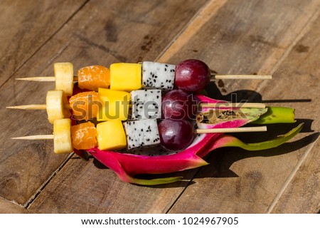Fresh tropical fruit on skewers in dragon fruit skin - healthy breakfast, weight loss concept. Thailand. Close up