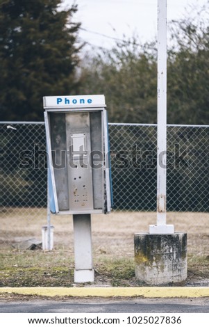 Abandoned payphone box. Phone is missing. Royalty-Free Stock Photo #1025027836