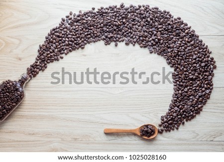 Black coffee seed on glass bottle on wood floor, free space