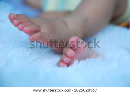 close up photos of baby's feet on a white blanket